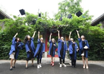 Para wisudawan melempar topi toga mereka ke udara di Universitas Peking di Beijing, ibu kota China, pada 2 Juli 2020. (Xinhua/Ren Chao)