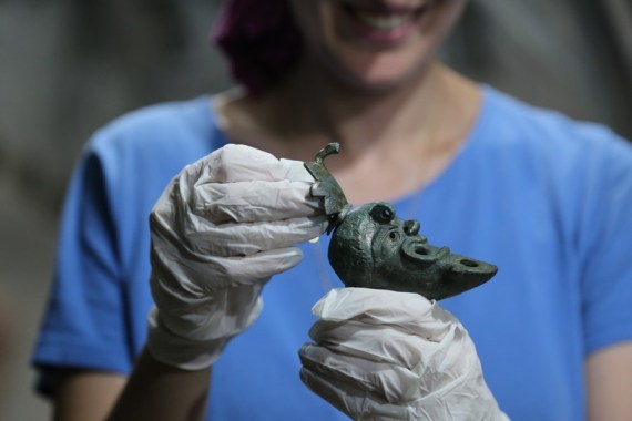 Seorang arkeolog Israel menunjukkan lampu minyak berbentuk separuh wajah berusia 1.900 tahun di situs arkeologi Kota Daud di Yerusalem pada 5 Mei 2021. (Xinhua/Shang Hao)