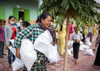Seorang wanita menerima makanan di provinsi Kampong Thom tengah, Kamboja DARI Program Pangan Dunia (WFP). [Handout via Xinhua]