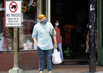 Orang-orang yang mengenakan masker terlihat di sebuah jalan di New Orleans, Louisiana, Amerika Serikat, pada 3 Agustus 2021. (Xinhua/Lan Wei)