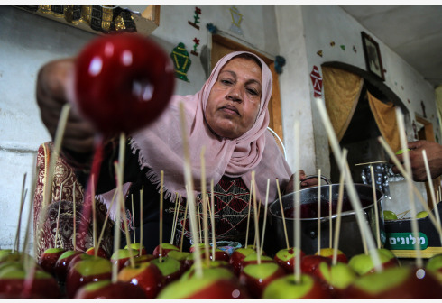 Warga Palestina Hanan Hamad (55) membuat permen apel yang dikenal sebagai "Halawa Anber" di Gaza, di dalam rumahnya di Kota Beit Hanoun, Jalur Gaza utara, pada 14 September 2021. (Xinhua/Rizek Abdeljawad)