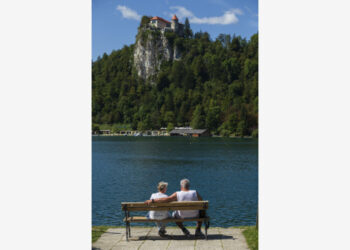 Orang-orang menikmati suasana hari yang cerah di tepi Danau Bled di Slovenia, pada 1 September 2021.  (Xinhua/Zeljko Stevanic)