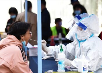 Seorang tenaga medis mengumpulkan sampel usap (swab) dari seorang wanita untuk pengujian asam nukleat di Harbin, Provinsi Heilongjiang, China timur laut, pada 22 September 2021. (Xinhua/Wang Jianwei)