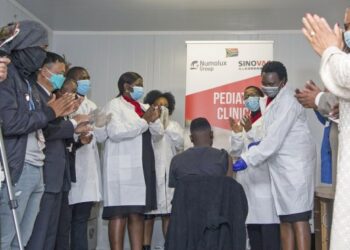 Orang-orang bertepuk tangan setelah seorang tenaga kesehatan menyuntikkan dosis vaksin CoronaVac Sinovac kepada seorang remaja di Pretoria, Afrika Selatan, pada 10 September 2021. (Xinhua/Chen Cheng)
