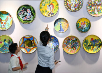 Seorang guru dan siswa mengamati berbagai karya seni yang ditampilkan pada Pekan Kerja sama Pendidikan China-ASEAN 2019 di Guiyang, ibu kota Provinsi Guizhou, China barat daya, pada 22 Juli 2019. (Xinhua/Yang Wenbin)