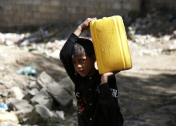 Seorang anak laki-laki Yaman memanggul jeriken air plastik di dekat keran air hasil sumbangan di Sanaa, Yaman, pada 28 Oktober 2021. (Xinhua/Mohammed Mohammed)