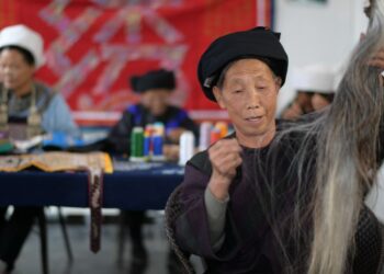 Seorang penyulam dari kelompok etnis Shui membuat benang jahit untuk sulaman ekor kuda tradisional dengan serat ekor kuda dan benang sutra di komunitas relokasi Xuehuahu di Zhonghe, Wilayah Otonom Etnis Shui Sandu, Provinsi Guizhou, China barat daya, pada 2 November 2021. (Xinhua/Yang Ying)