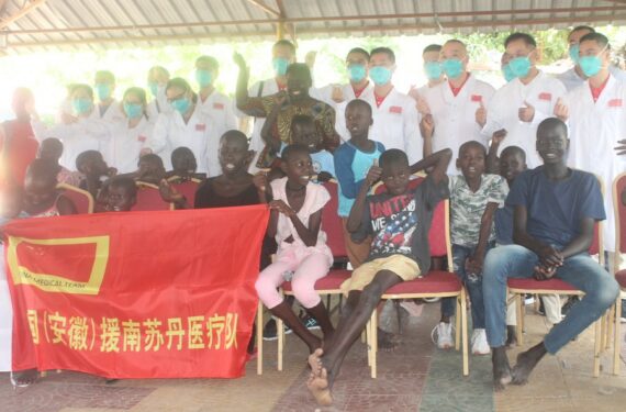 Para anggota tim medis China gelombang kesembilan di Sudan Selatan berpose untuk difoto bersama anak-anak di Juba, ibu kota Sudan Selatan, pada 21 November 2021. (Xinhua/Denis Elamu)