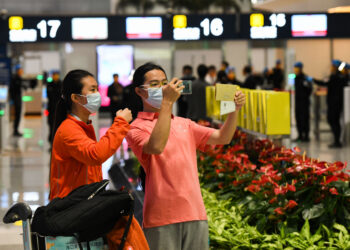 HAIKOU, Seorang penumpang mengabadikan foto kartu boarding pass di Terminal 2 Bandar Udara Internasional Meilan di Haikou, Provinsi Hainan, China selatan, pada 2 Desember 2021. Proyek perluasan Bandar Udara Internasional Meilan di pulau resor Hainan, China selatan, secara resmi dioperasikan pada 2 Desember. Proyek tersebut terdiri dari sebuah terminal baru, landasan pacu sepanjang 3.600 meter, dan fasilitas transportasi darat. (Xinhua/Yang Guanyu)