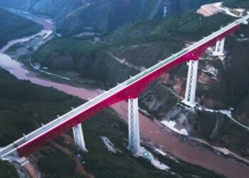 Foto dari udara ini menunjukkan kereta rel listrik (electric multiple unit/EMU) Jalur Kereta China-Laos melintasi sebuah jembatan utama di atas Sungai Yuanjiang di Provinsi Yunnan, China barat daya, pada 3 Desember 2021. (Xinhua/Wang Guansen)