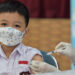 JAKARTA, Seorang anak menerima suntikan vaksin COVID-19 di Jakarta pada 11 Januari 2022. Pemerintah Indonesia terus mengintensifkan vaksinasi untuk anak-anak berusia 6 hingga 11 tahun di seluruh negeri. (Xinhua/Veri Sanovri)