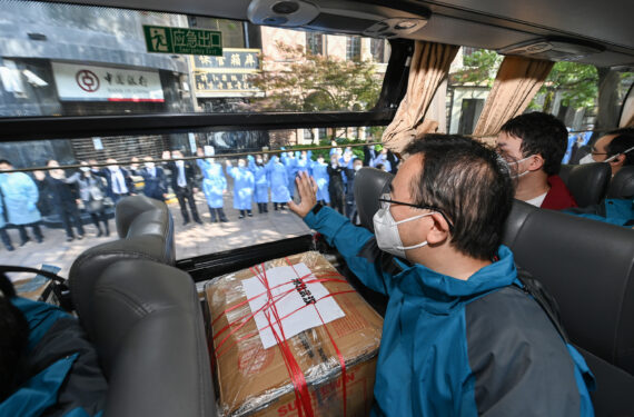 SHANGHAI, Anggota tim bantuan tes asam nukleat melambaikan tangan kepada orang-orang di Shanghai, China timur, pada 14 Mei 2022. Sebanyak 207 anggota tim bantuan tes asam nukleat dari Provinsi Hubei meninggalkan Shanghai setelah menuntaskan misi mereka. (Xinhua/Li He)