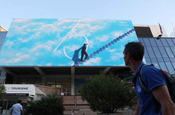 CANNES, Seorang pria berjalan melewati sebuah poster di luar Palais des Festival menjelang Festival Film Cannes ke-75 di Cannes, Prancis selatan, pada 16 Mei 2022. Festival Film Cannes ke-75 rencananya akan digelar mulai 17 sampai 28 Mei. (Xinhua/Gao Jing)