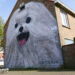 OSTEND, Seorang pria berjalan dengan seekor anjing melewati sebuah mural di Ostend, Belgia, pada 18 Mei 2022. Dalam beberapa tahun terakhir, para seniman menggunakan fasad bangunan di Ostend sebagai kanvas dan menciptakan berbagai mural sebagai karya seni jalanan. (Xinhua/Zheng Huansong)