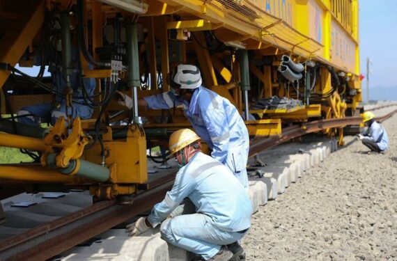 BANDUNG, Sejumlah karyawan bekerja di lokasi konstruksi peletakan rel berbantalan bebatuan (ballasted track) di jalur utama Kereta Cepat Jakarta-Bandung (KCJB) di Bandung, Provinsi Jawa Barat. Seiring sepasang rel pertama dengan panjang 500 meter yang perlahan-lahan ditarik keluar dari kereta pengangkutnya, KCJB memulai peletakan ballasted track di jalur utama tersebut, menandai dimulainya tahap konstruksi pemasangan untuk jalur kereta itu. (Xinhua/Li Xiangning)