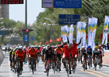 GOLMUD, Li Boan (keempat dari kiri, depan) asal Henan melintasi garis finis dalam etape 8 balap sepeda Tur Danau Qinghai 2022, edisi ke-21 tahun ini, di Provinsi Qinghai, China barat laut, pada 3 Agustus 2022. (Xinhua/Zhang Long)