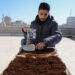 GAZA CITY, Abdullah al-Safadi mengumpulkan ampas kopi untuk digunakan sebagai pupuk tanaman di Gaza City, pada 19 Januari 2023. Abdullah al-Safadi, seorang pemuda Gaza berusia 20-an, menggalakkan daur ulang ampas kopi menjadi pupuk organik di komunitasnya. (Xinhua/Rizek Abdeljawad)